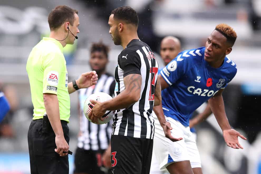 Everton’s Yerry Mina (right) did his best to put off Newcastle’s Callum Wilson as he prepared to take his penalty