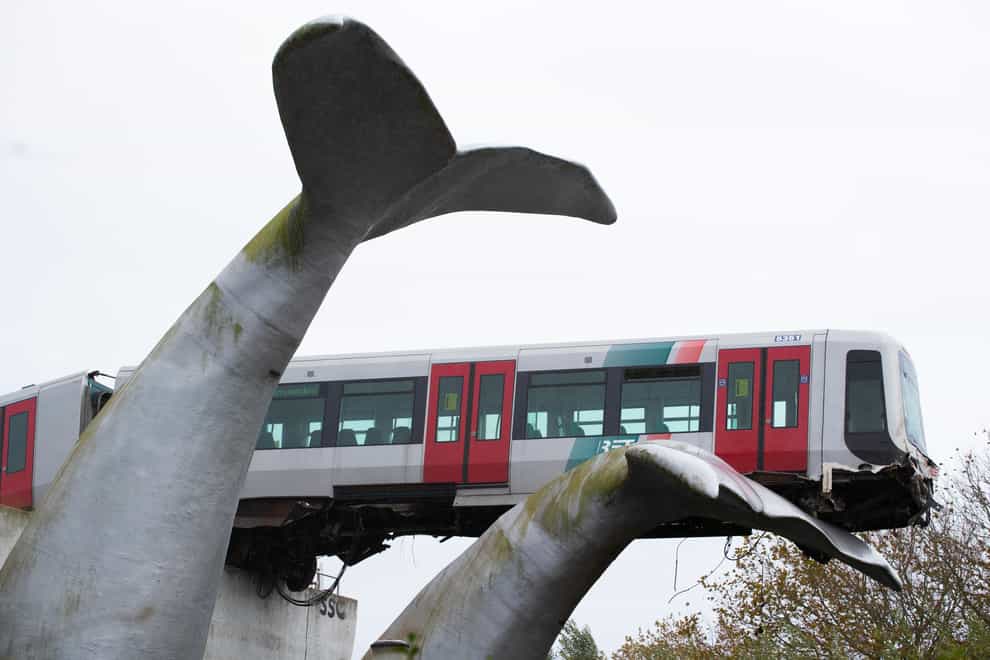 A train stranded on a whale sculpture