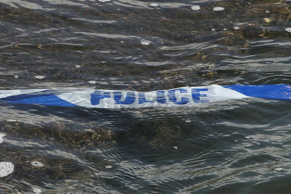 Police tape floats in the sea