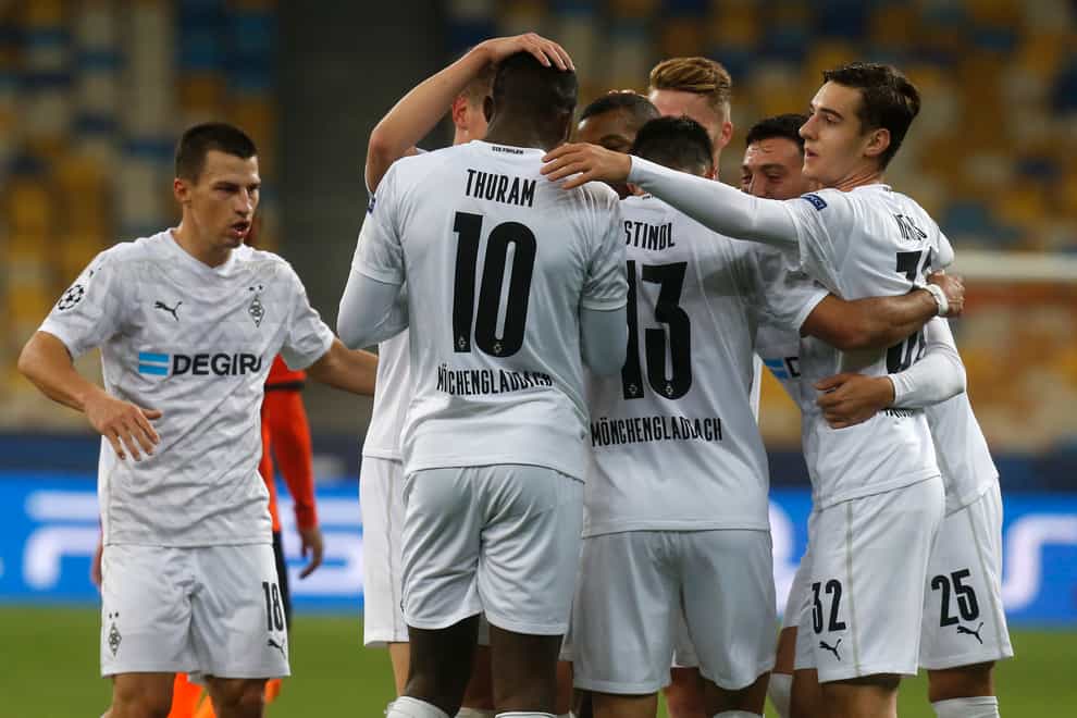 Borussia Monchengladbach’s Alassane Plea celebrates with his team-mates after scoring his side’s third goal at Shakhtar Donetsk (Efram Lukatsky
