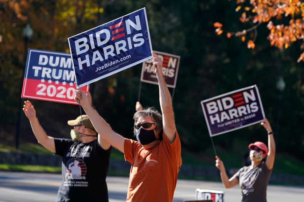 Supporters of president-elect Joe Biden wave signs