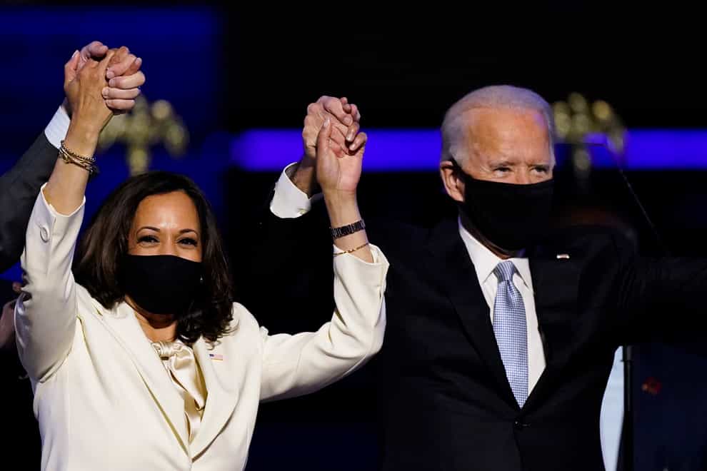 Vice President-elect Kamala Harris holds hands with President-elect Joe Biden