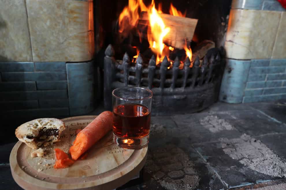 Amince pie, glass of sherry and a carrot for a reindeer is left by a fireplace (Owen Humphreys/PA)