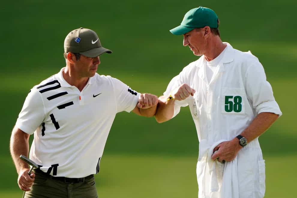 Paul Casey celebrates with his caddie John MacLaren after his opening 65 at the Masters