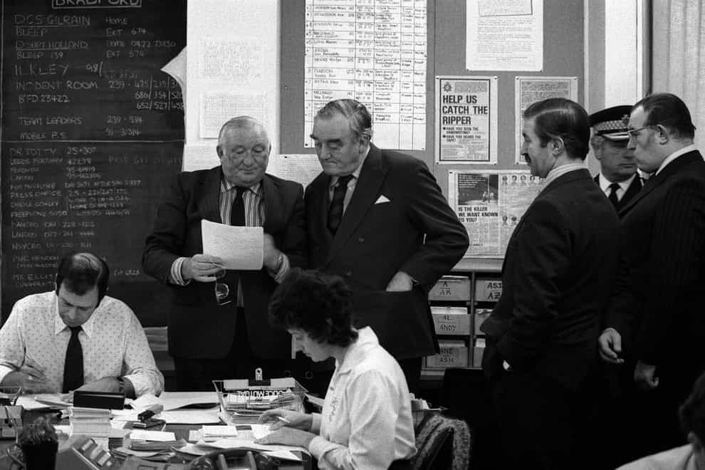 Then home secretary William Whitelaw visits the incident room of the Yorkshire Ripper at Leeds Millgarth Police headquarters while Assistant Chief Constable George Oldfield (left) explains details of the cases (Archive/PA)