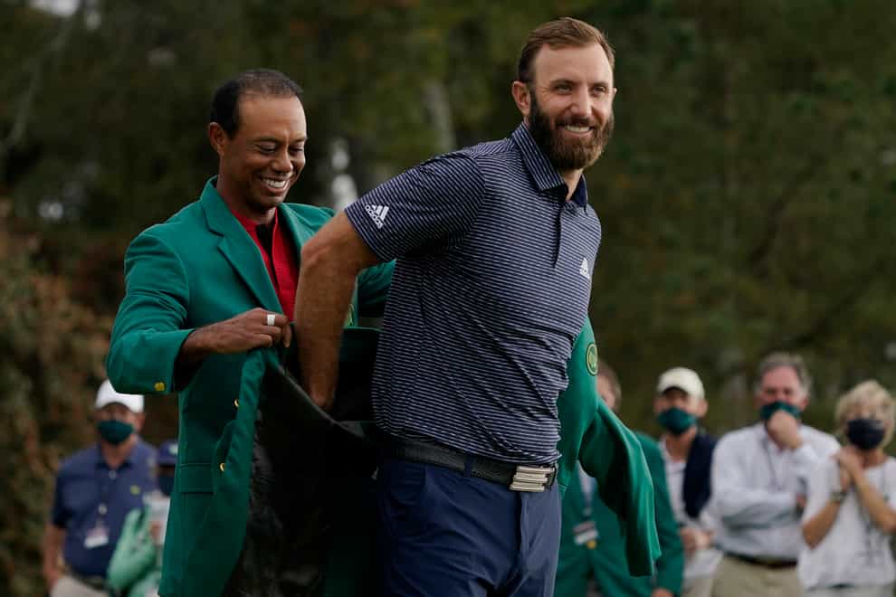 Tiger Woods helps Masters’ champion Dustin Johnson with his green jacket
