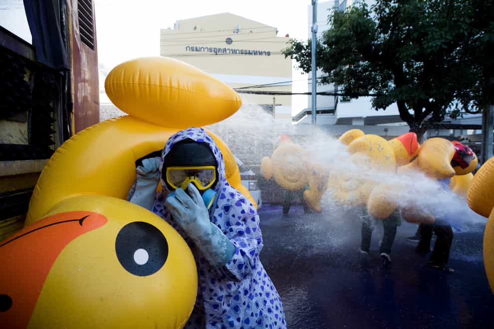 Pro-democracy protesters take cover with inflatable ducks