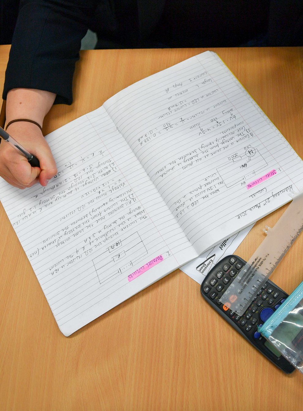 Students write in their exercise books