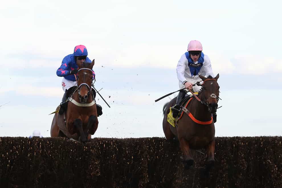Waiting Patiently and Brian Hughes (right) lead Cue Card and Paddy Brennan away from the last fence before going on to win the 2018 Betfair Ascot Steeple Chase