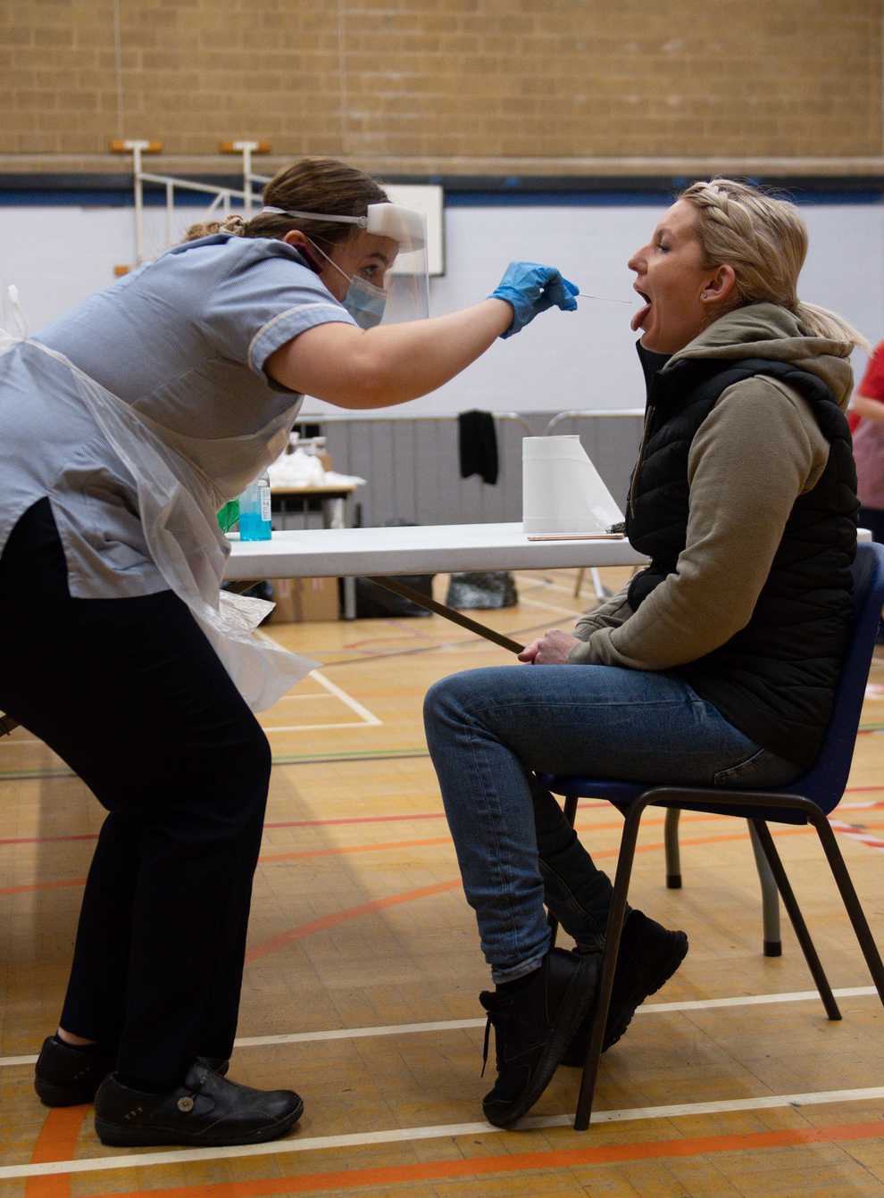 A nurse administers a test at Dimensions Leisure Centre in Stoke-on-Trent (Jacob King/PA)