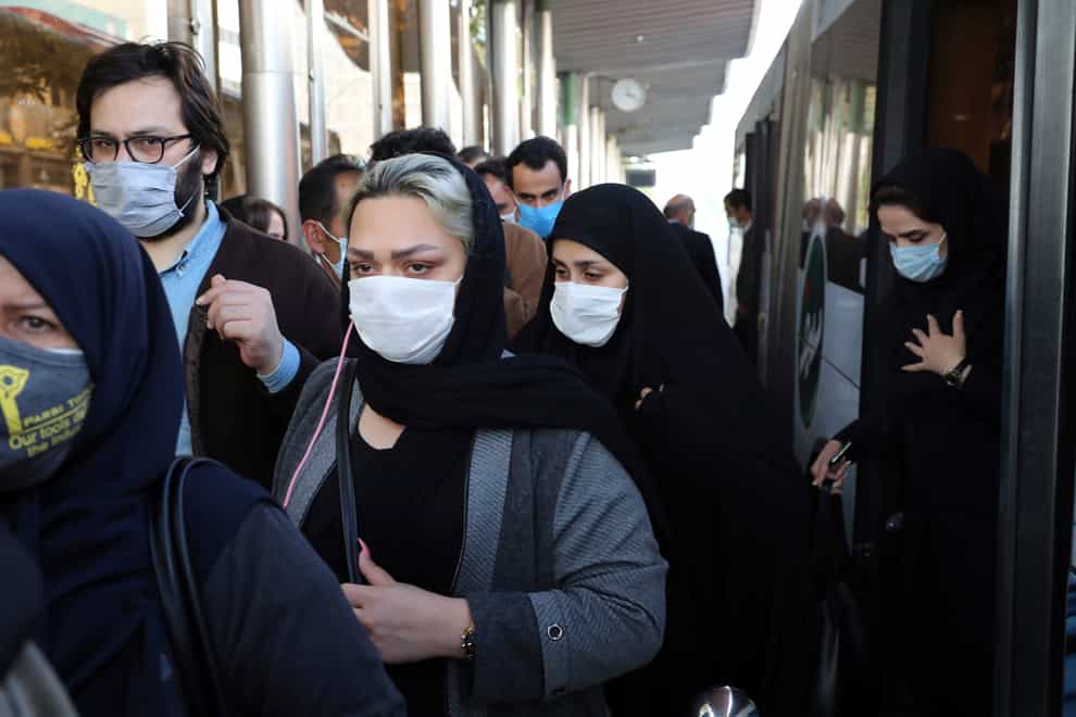 People wear protective face masks to help prevent the spread of coronavirus in Tehran, Iran