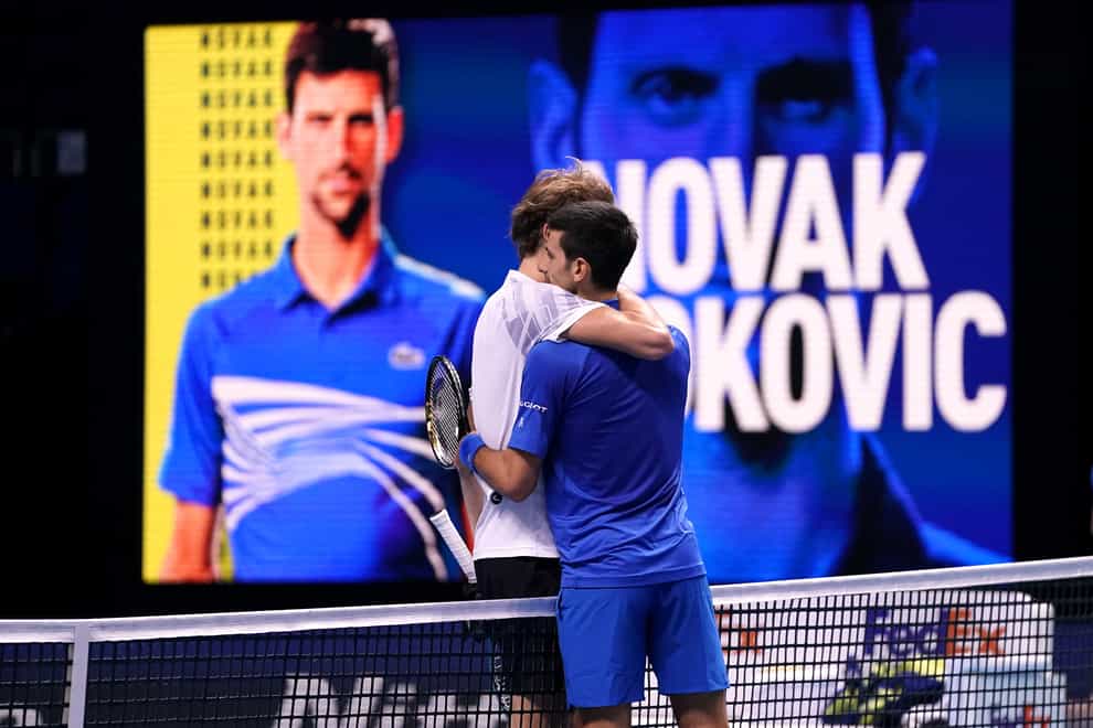 Novak Djokovic (right) embraces Alexander Zverev after their match at The O2