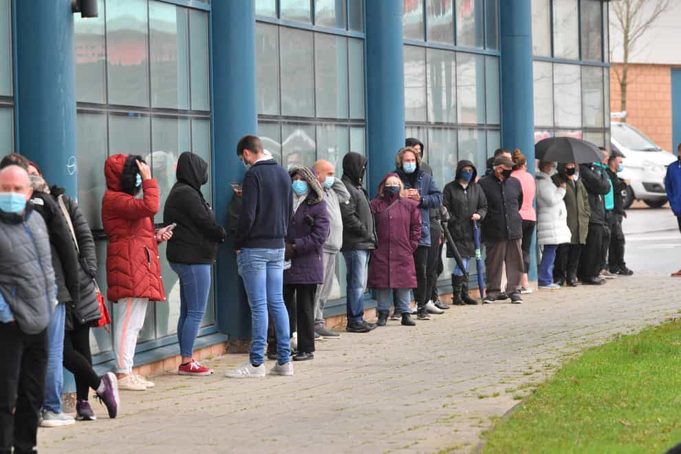 Members of the public queue for a Covid-19 test at Rhydycar leisure centre in Merthyr Tydfil