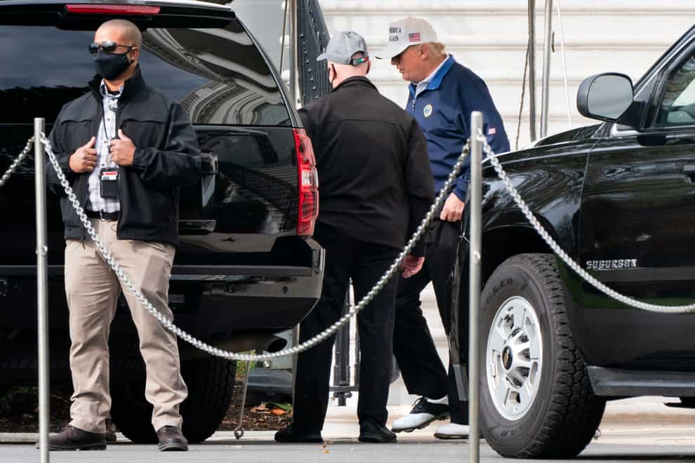Donald Trump walks to a motorcade