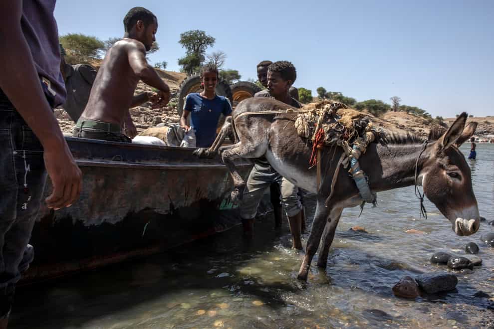Tigray refugees who fled the conflict in the Ethiopia’s Tigray arrive with their donkey