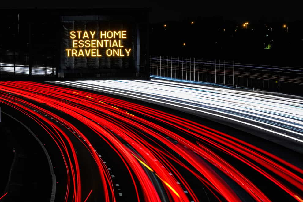 A stay home, essential travel only sign on the M1 Motorway