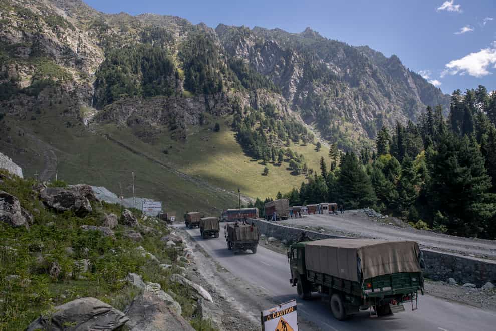 An Indian army convoy moves on the Srinagar- Ladakh road at Gagangeer, northeast of Srinagar (Dar Yasin/AP)