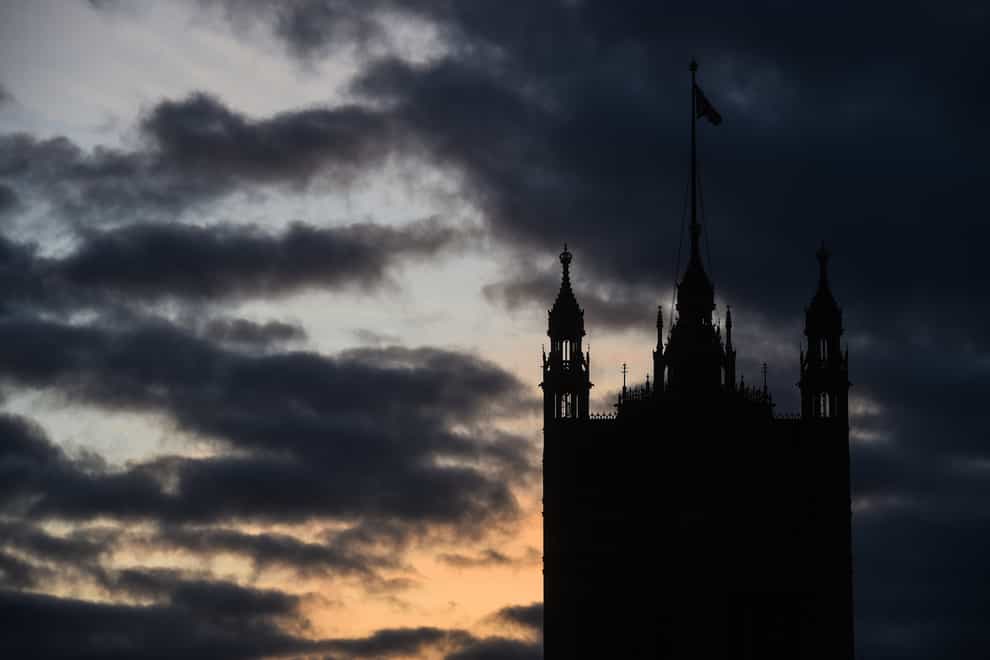 The sun sets behind the Houses of Parliament in Westminster