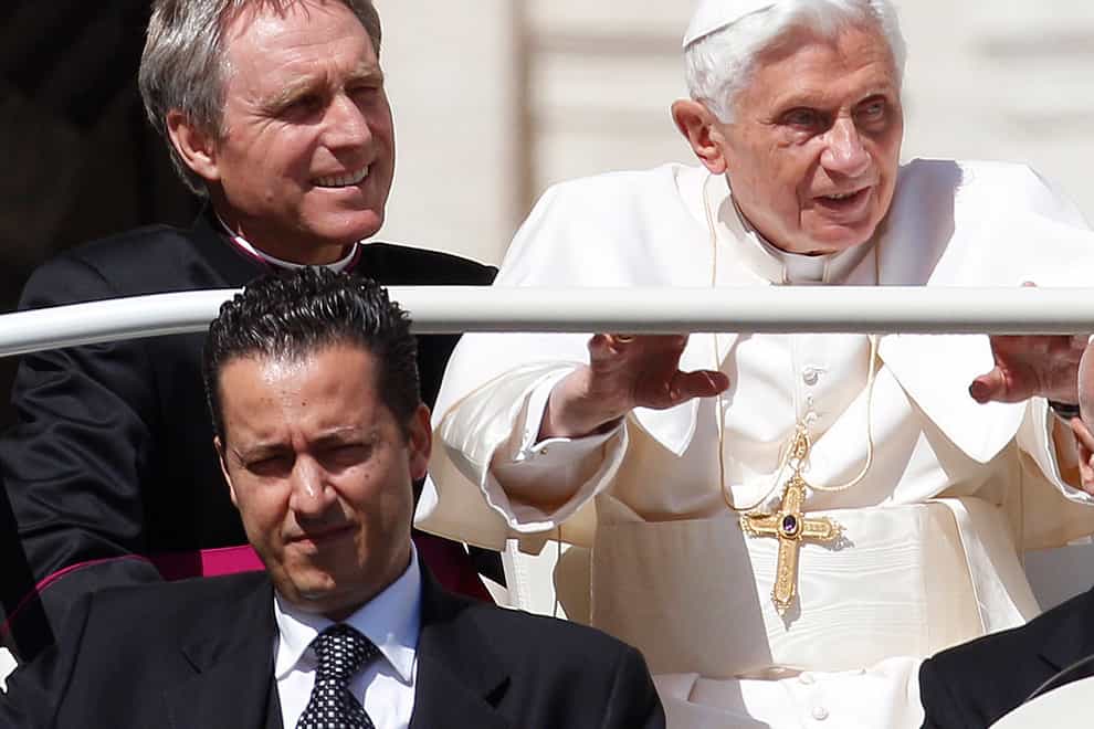 Pope Benedict XVI, right, arrives in St. Peter’s square at the Vatican for a general audience as his then-butler Paolo Gabriele, bottom, and his personal secretary Georg Gaenswein sitting in the car with him (Alessandra Tarantino/AP)
