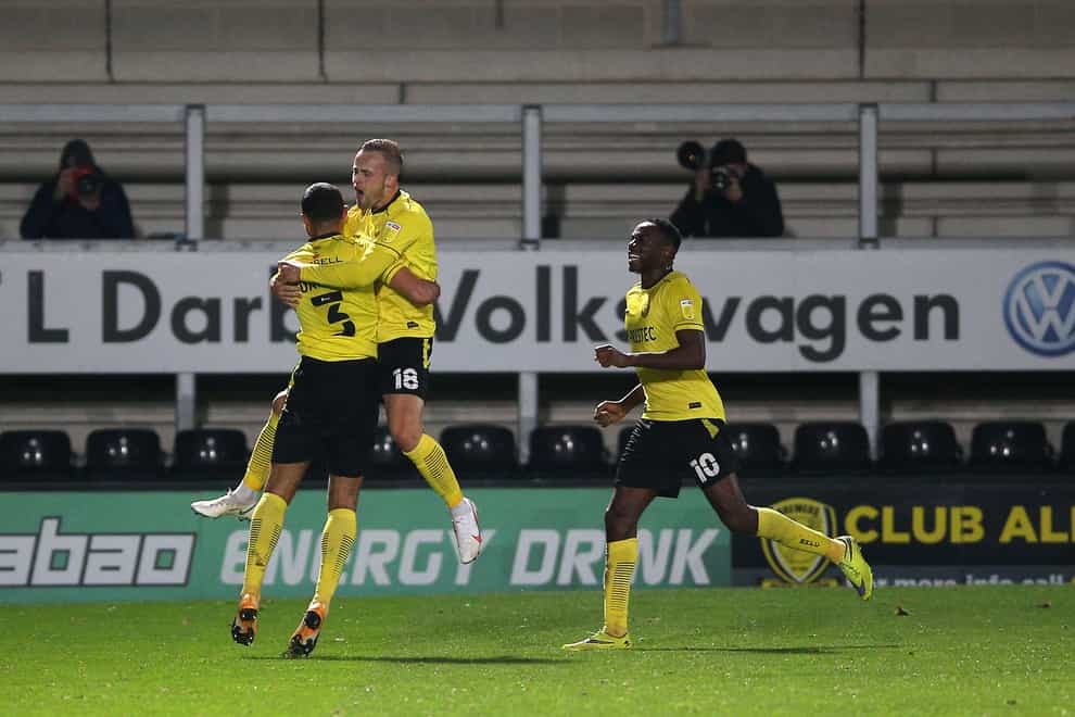 Charles Vernam, centre, celebrates scoring Burton’s fourth goal