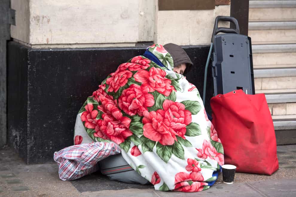 A homeless person outside Victoria Station in London (Victoria Jones/PA)