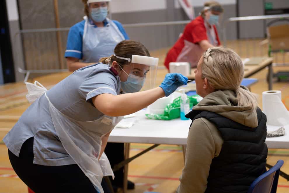 A nurse administers a coronavirus test