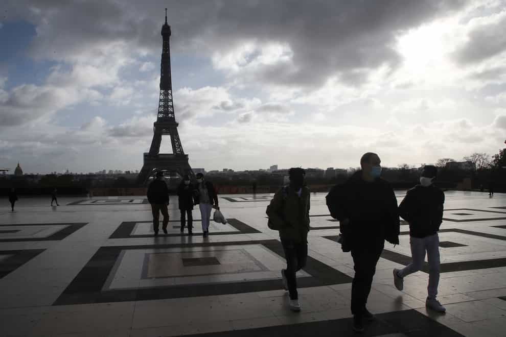 People wearing face masks make their way on the Trocadero square, near the Eiffel Tower (Michel Euler/AP)