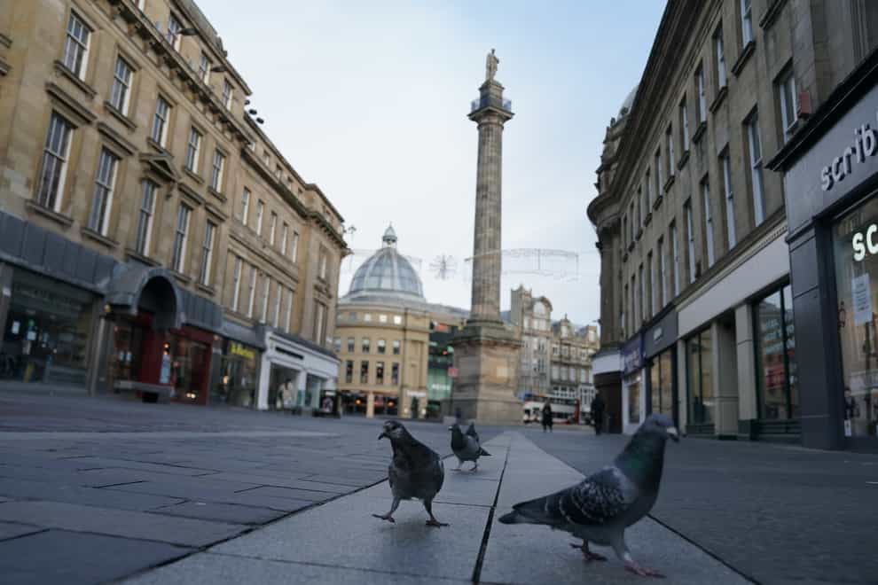 Pigeons occupy empty streets near the Grey’s Monument in Newcastle