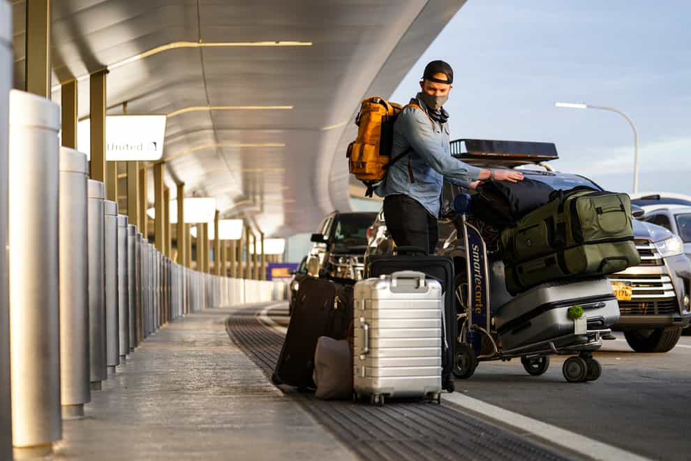 Travellrs arrive at Terminal C at LaGuardia Airport, New York (John Minchillo/AP)