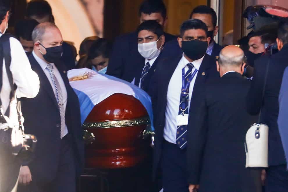 The flag-draped casket of Diego Maradona is carried to a waiting hearse
