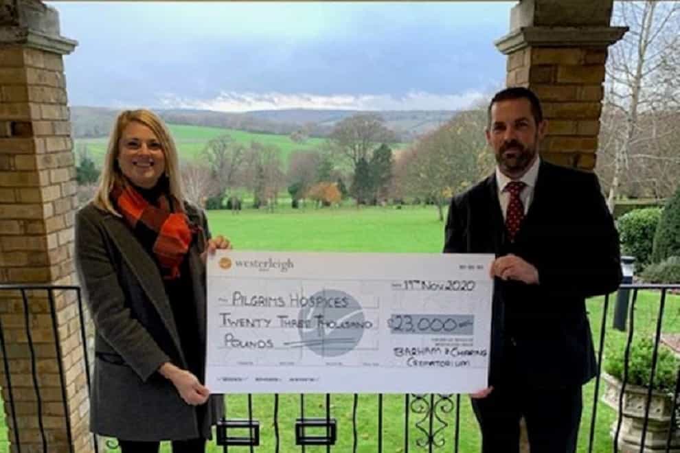 Darren Daughters giving a cheque to a representative of Pilgrims Hospices