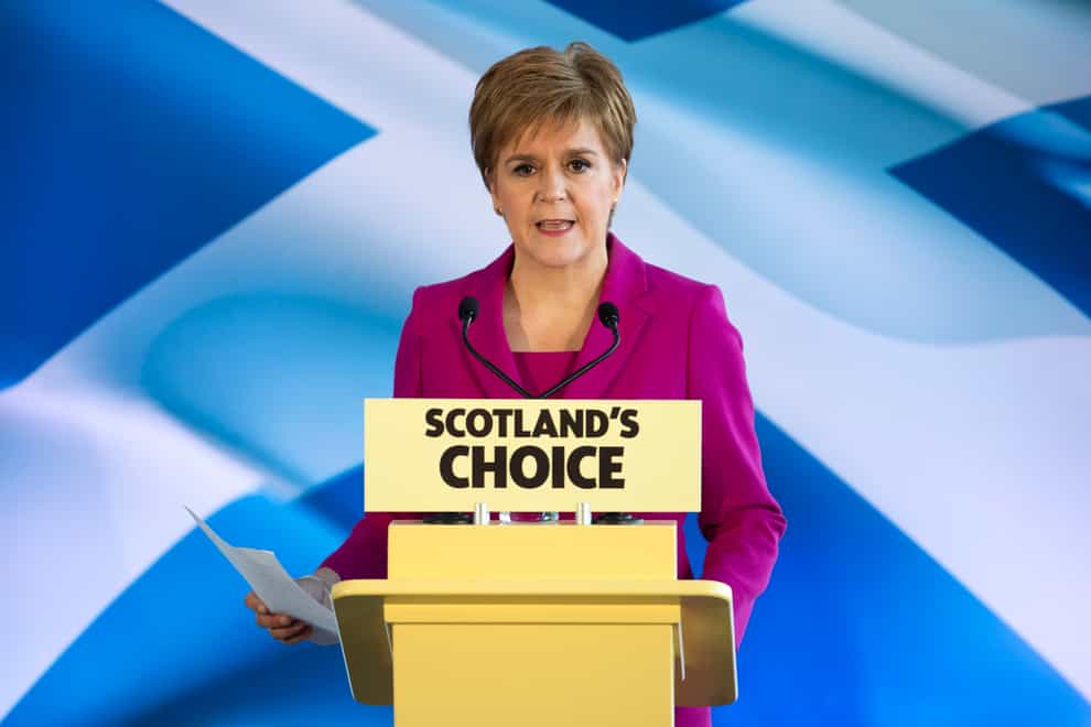 Nicola Sturgeon in front of a saltire and behind a podium with Scotland's choice written on it