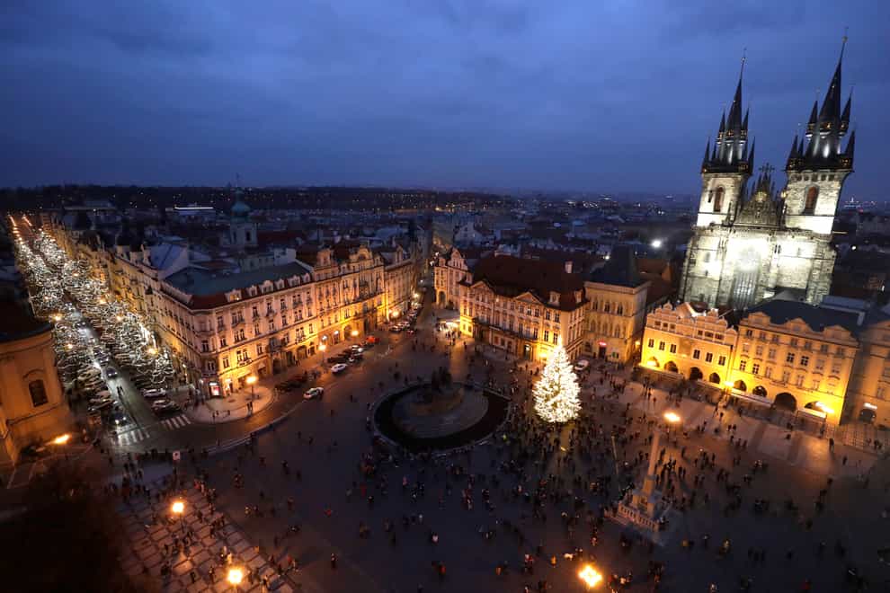 A Christmas tree illuminates the Old Town Square in Prague