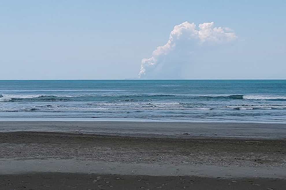 The view of the volcano eruption on White Island in New Zealand from Ohope Beach, the closest point on the mainland to the island