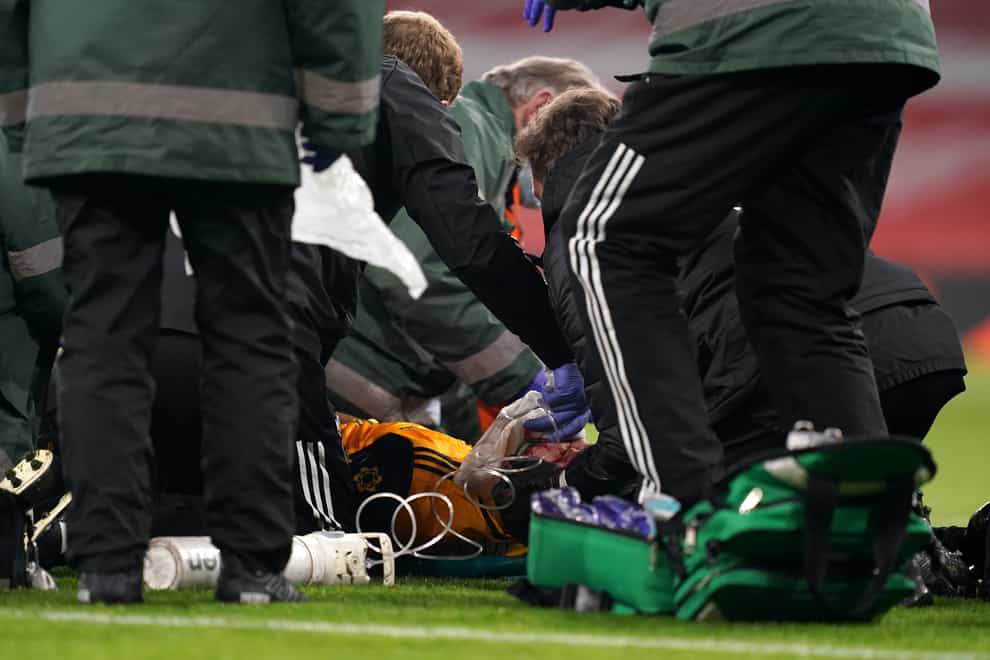 Raul Jimenez receives treatment on the pitch at the Emirates