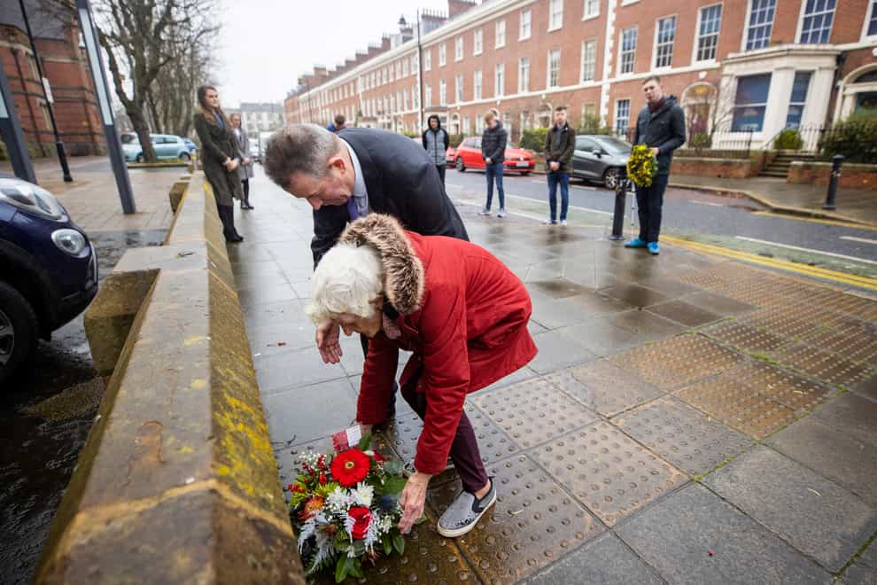 Maura Babbington and her son Marcus lay a wreath ahead of the anniversary of the death of lawyer Edgar Graham