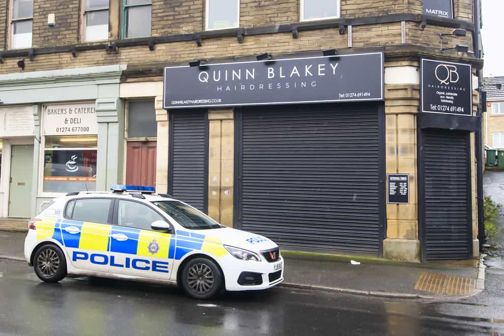 A police car parked outside Quinn Blakey Hairdressing in Oakenshaw, Bradford, West Yorkshire