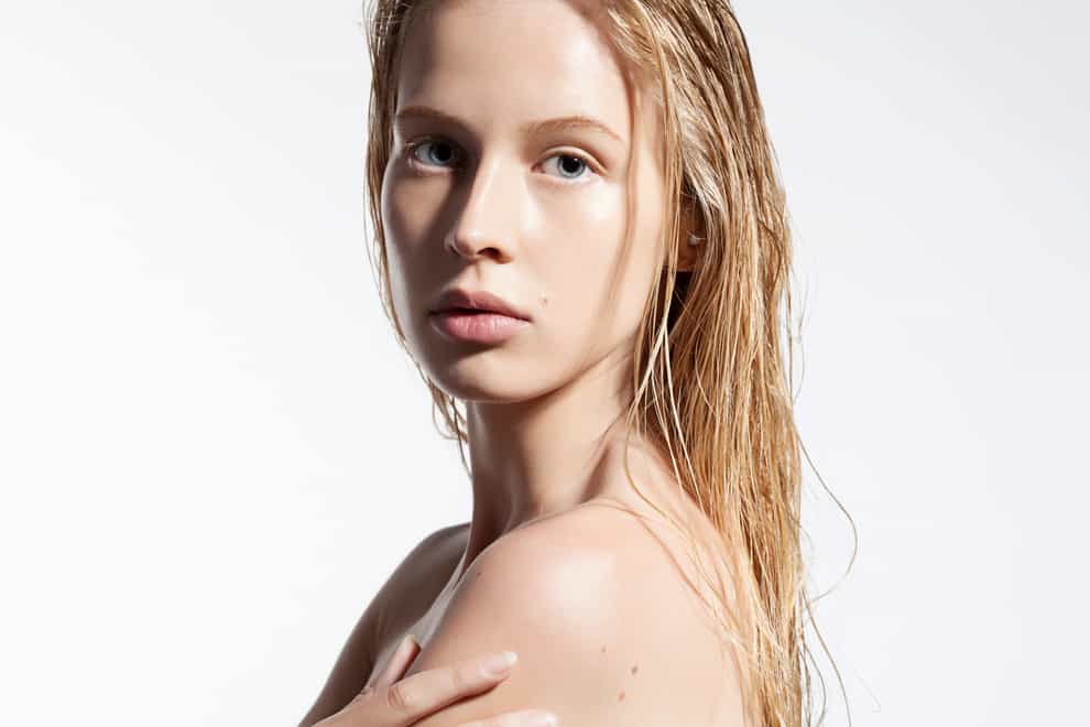 Woman with dewy skin and wet hair