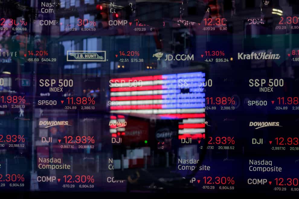 A United States flag is reflected in the window of the Nasdaq studio (Seth Wenig/AP)