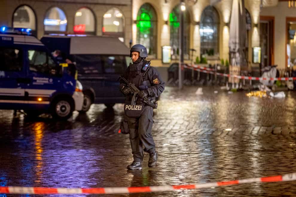 A police officer guards evidence at the scene of the incident in Trier, Germany (Michael Probst/AP)