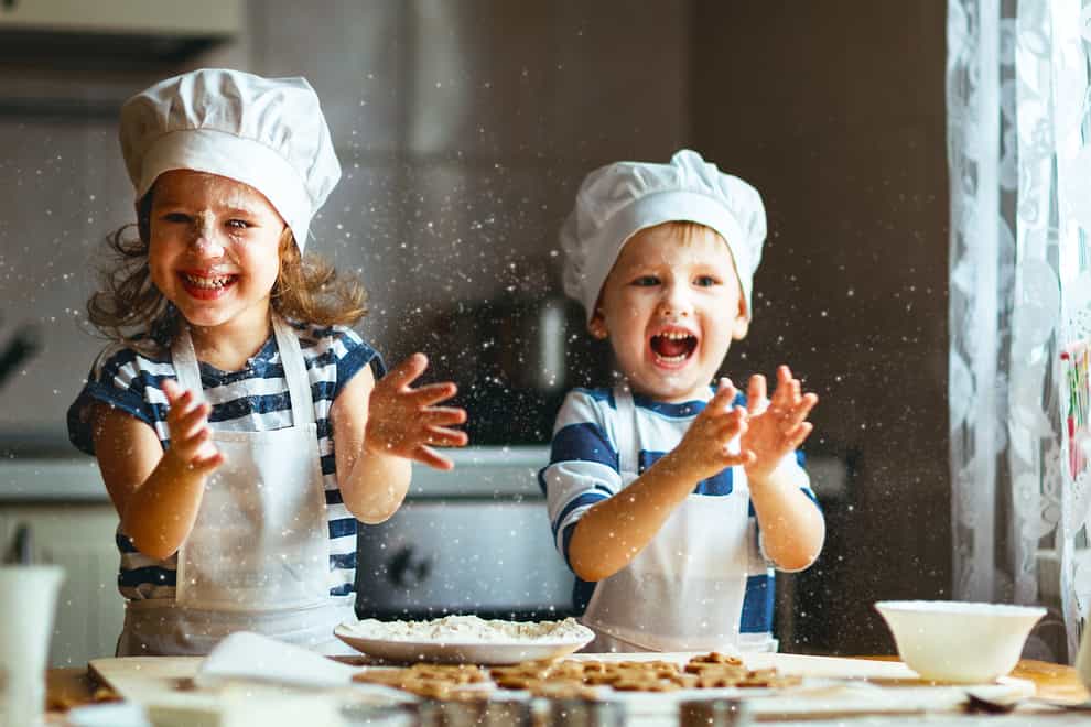 Two kids Christmas baking (iStock/PA)
