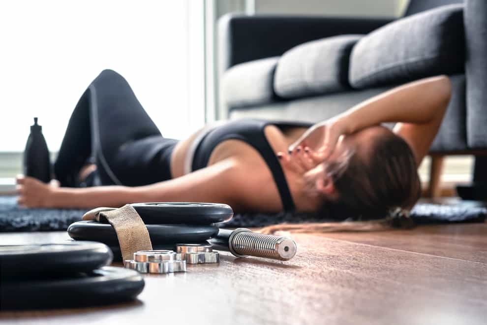 woman after working out, laying on the floor