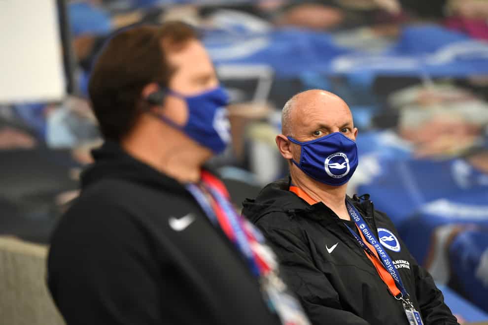 Staff at Brighton wear face coverings at a match against Manchester United