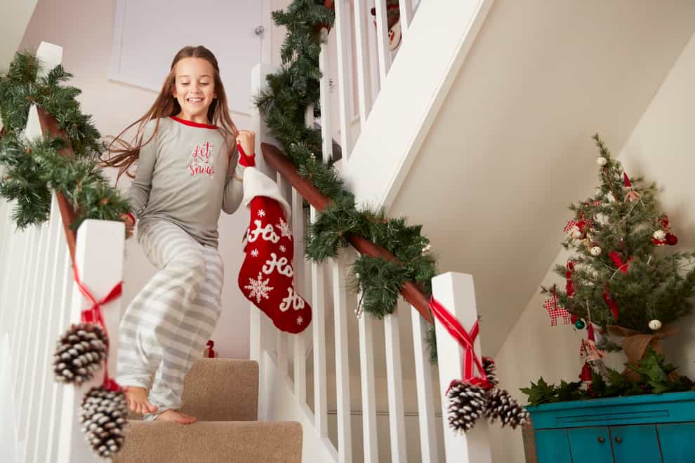 girl coming down the stairs on Christmas Day