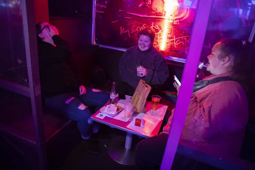 People eating McDonald's in G-A-Y bar