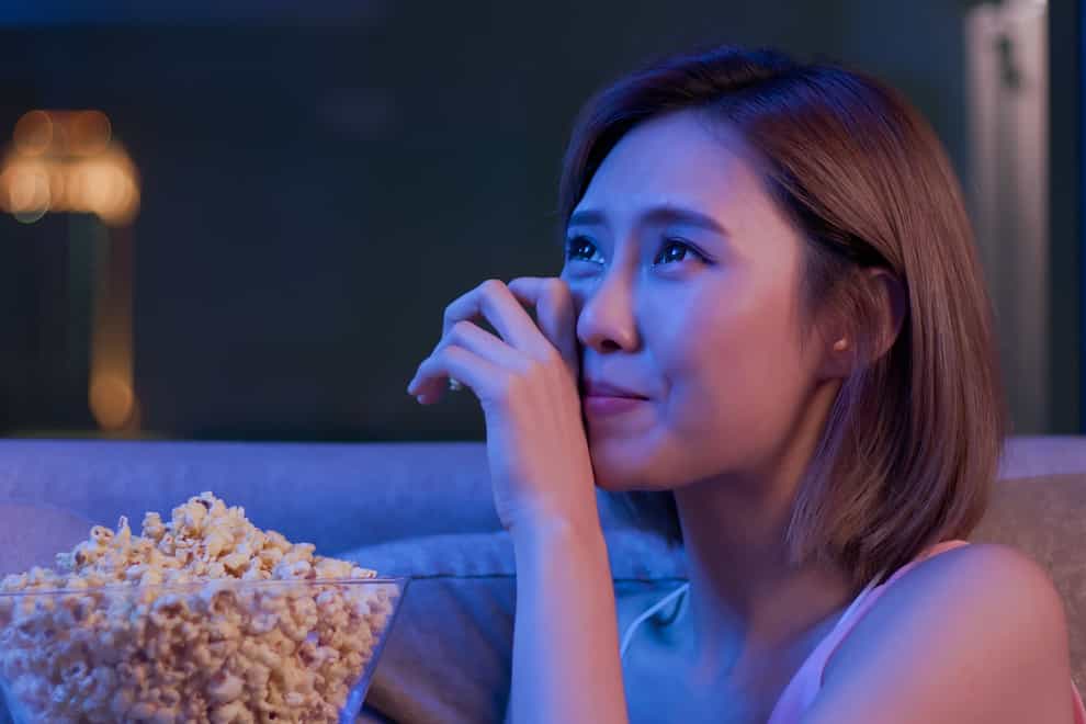 Young woman cry while watching a very touching movie (iStock/PA)