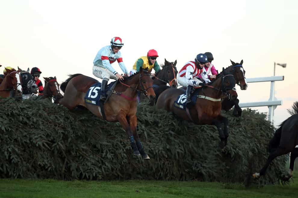 Beau Bay (right) and Charlie Hammond on their way to winning the William Hill Grand Sefton Handicap Chase at Aintree