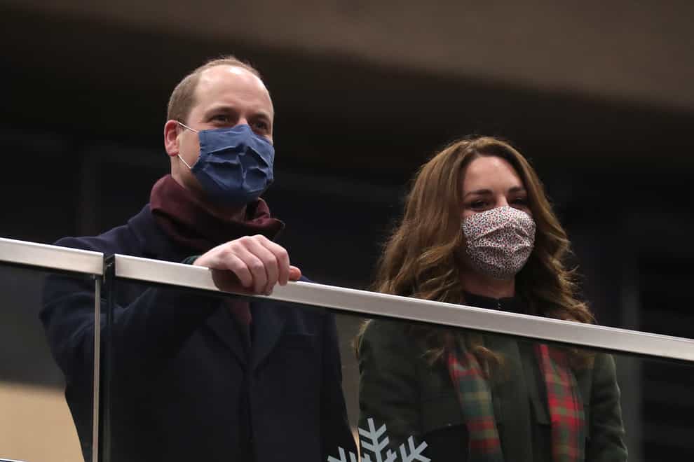 The Duke and Duchess of Cambridge look on from the balcony at London Euston Station ahead of boarding the royal train as they leave London for a tour across the UK. Chris Jackson/PA Wire