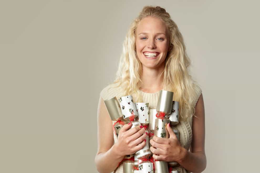 woman holding a bunch of Christmas crackers