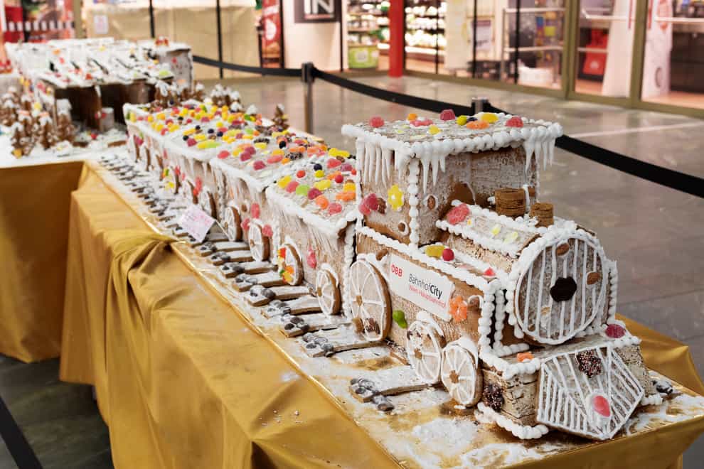 Gingerbread train decorated with icing, candies, chocolate and other sweets displayed at Vienna main train station during Christmas time.